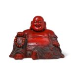 A CHINESE CINNABAR LACQUER FIGURE OF BUDAI HESHANG.