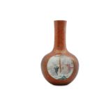 A CHINESE FAMILLE ROSE CORAL-GROUND BOTTLE VASE.
