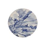 A CHINESE BLUE AND WHITE CIRCULAR 'PLOUGHMAN' PANEL.