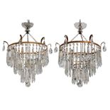 A pair of early 20th Century gilt metal two tier chandeliers