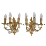 A pair of 20th Century French three branch gilt metal wall sconces