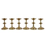 A set of six 20th Century brass candlesticks in the Arts and Crafts style
