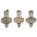 A set of three 20th Century French gilt metal four light chandeliers