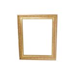 A FRENCH 19TH CENTURY EMPIRE STYLE GILDED COMPOSITION FRAME