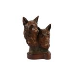 A modern British terracotta sculpture of two foxes