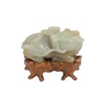 A Chinese pale celadon jade carving of a water buffalo in recumbant position