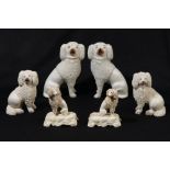 Three pairs of Staffordshire porcelain seated poodles