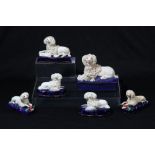 A pair of Staffordshire pottery poodle and pup groups
