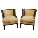 A pair of contemporary walnut bergere style armchairs