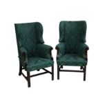 A pair of early 19th century mahogany reclining wingback armchairs