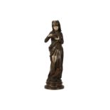 AN EARLY 20TH PATINATED BRONZE AND CARVED IVORY FIGURE OF 'LA LISEUSE' AFTER A MODEL BY