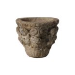 AN EARLY MEDIEVAL CARVED STONE MORTAR OR VESSEL DECORATED WITH GROTESQUES