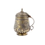 A SILVER-GILT REPOUSSÉ LIDDED TANKARD