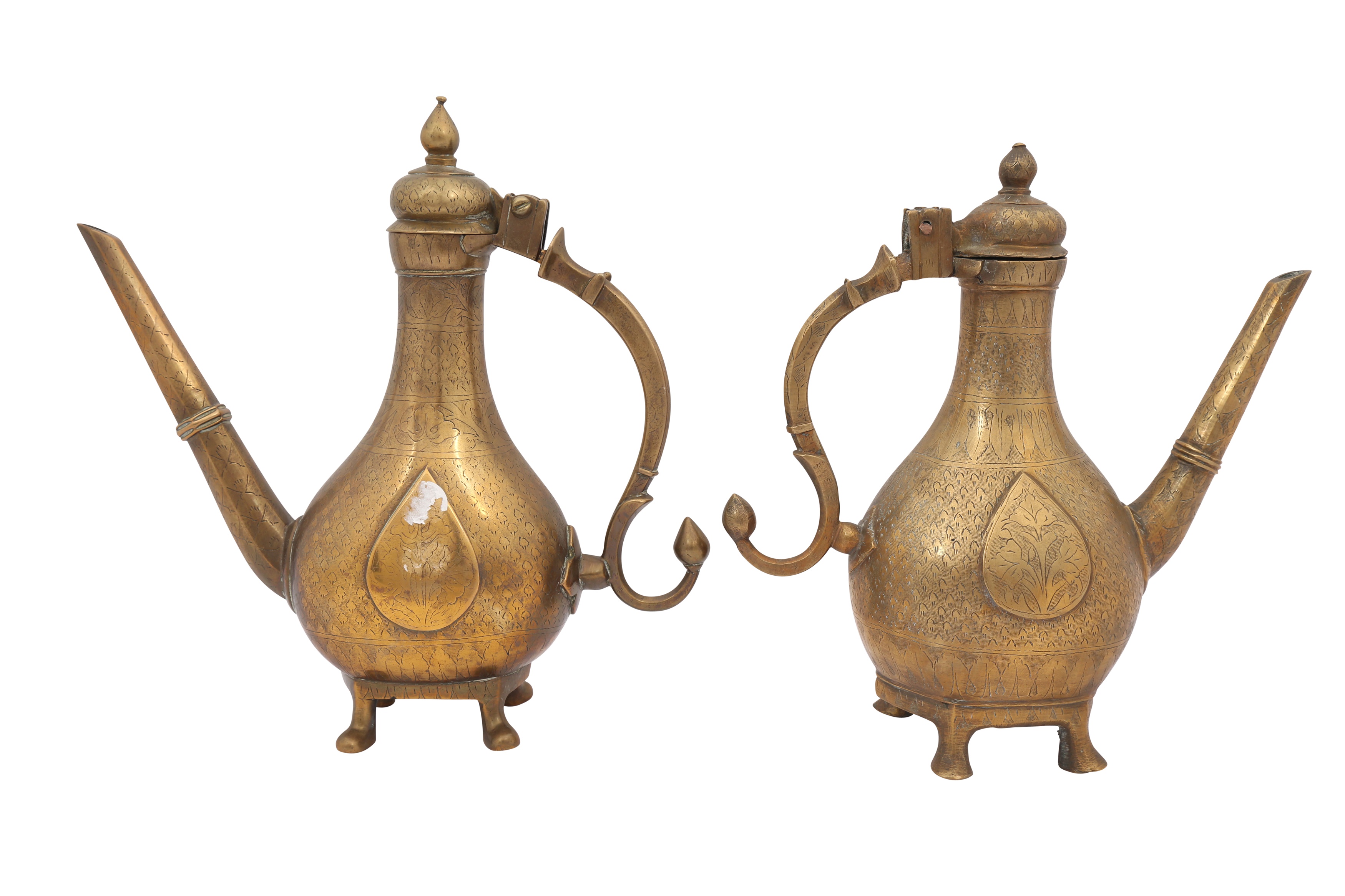 A NEAR PAIR OF ENGRAVED MINIATURE BRASS EWERS (AFTABEH)