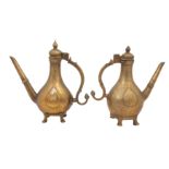 A NEAR PAIR OF ENGRAVED MINIATURE BRASS EWERS (AFTABEH)