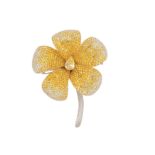 A yellow sapphire and diamond floral brooch