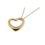 A gold 'Open Heart' pendant necklace and earstuds, by Elsa Peretti for Tiffany & Co.