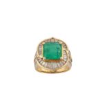 An emerald and diamond dress ring