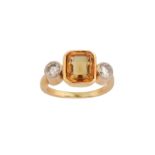 A yellow sapphire and diamond ring