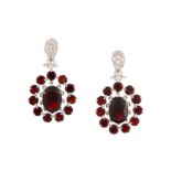 A diamond and garnet ring and earrings suite