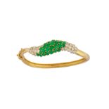 An emerald and diamond bangle