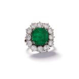 An emerald and diamond cluster ring