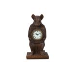 A BLACK FOREST STYLE CARVED WOODEN MANTLE CLOCK