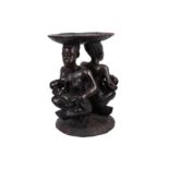 A WEST AFRICAN TRIBAL CARVED HARDWOOD MATERNITY FIGURE STOOL / TABLE