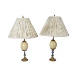 A NEAR PAIR OF MID 20TH CENTURY BRASS MOUNTED OSTRICH EGG AND LAPIS LAZULI TABLE LAMPS