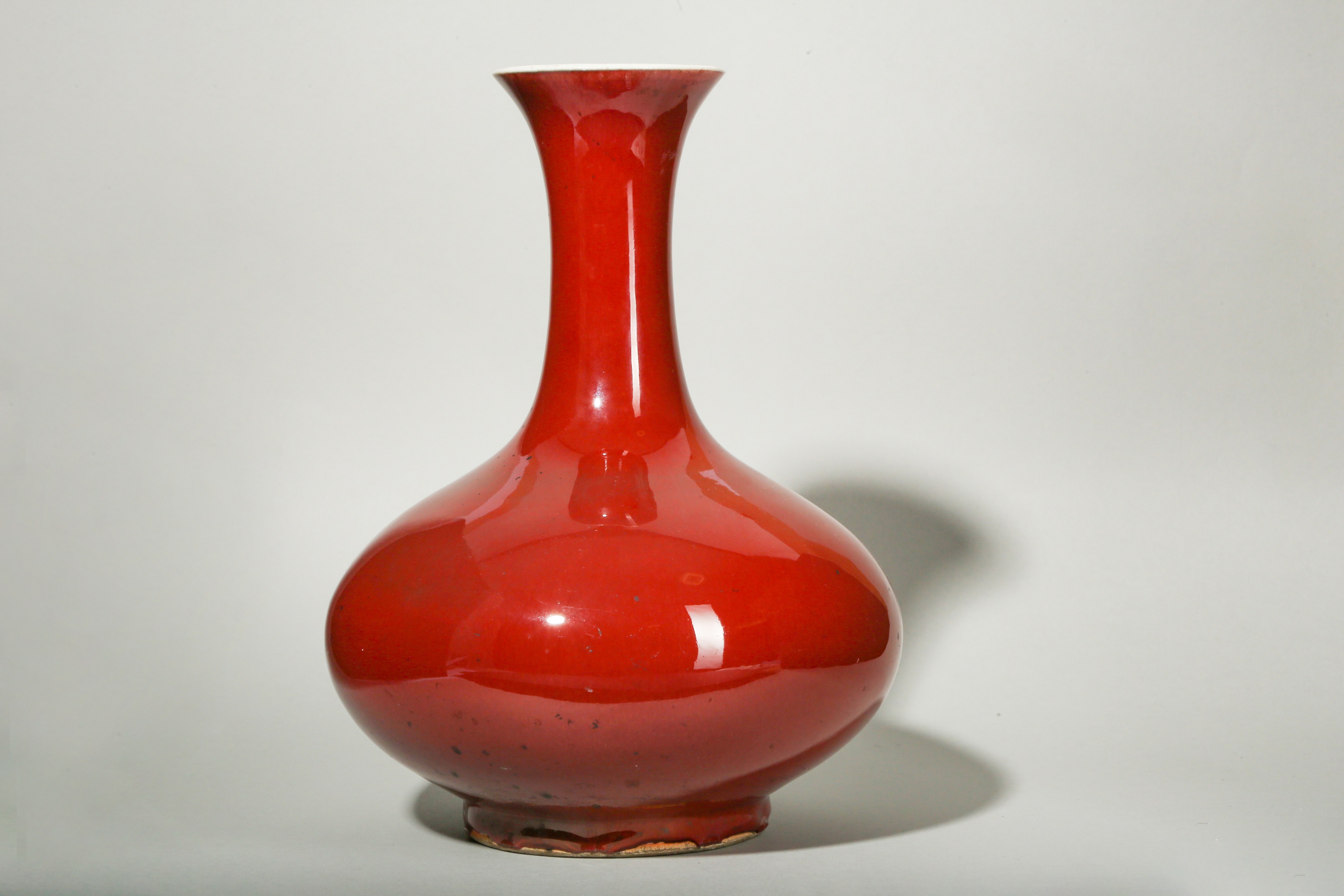 A CHINESE COPPER RED-GLAZED BOTTLE VASE.