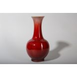 A CHINESE COPPER RED-GLAZED BOTTLE VASE.