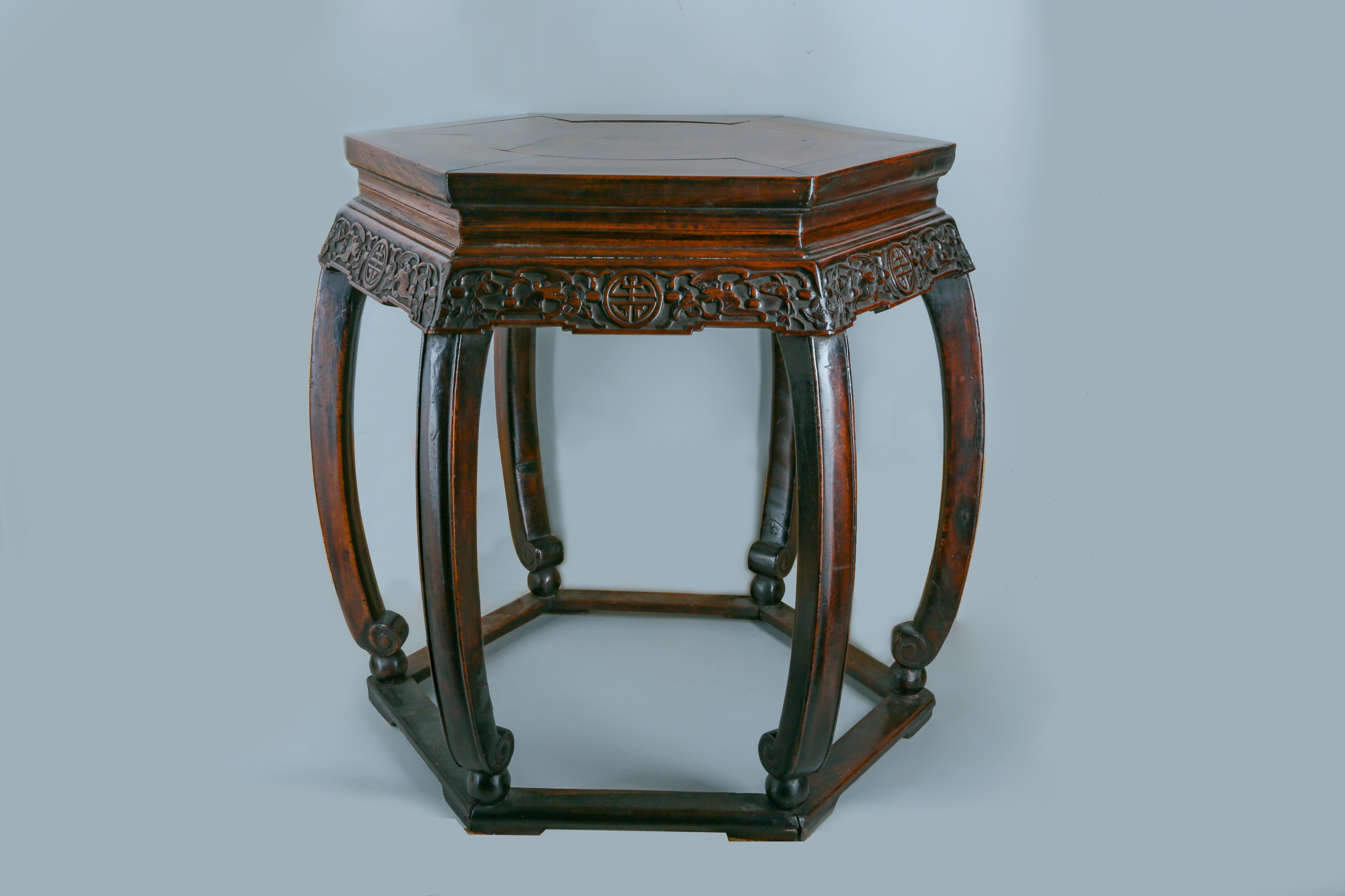 A CHINESE HEXAGONAL CARVED WOOD STAND.