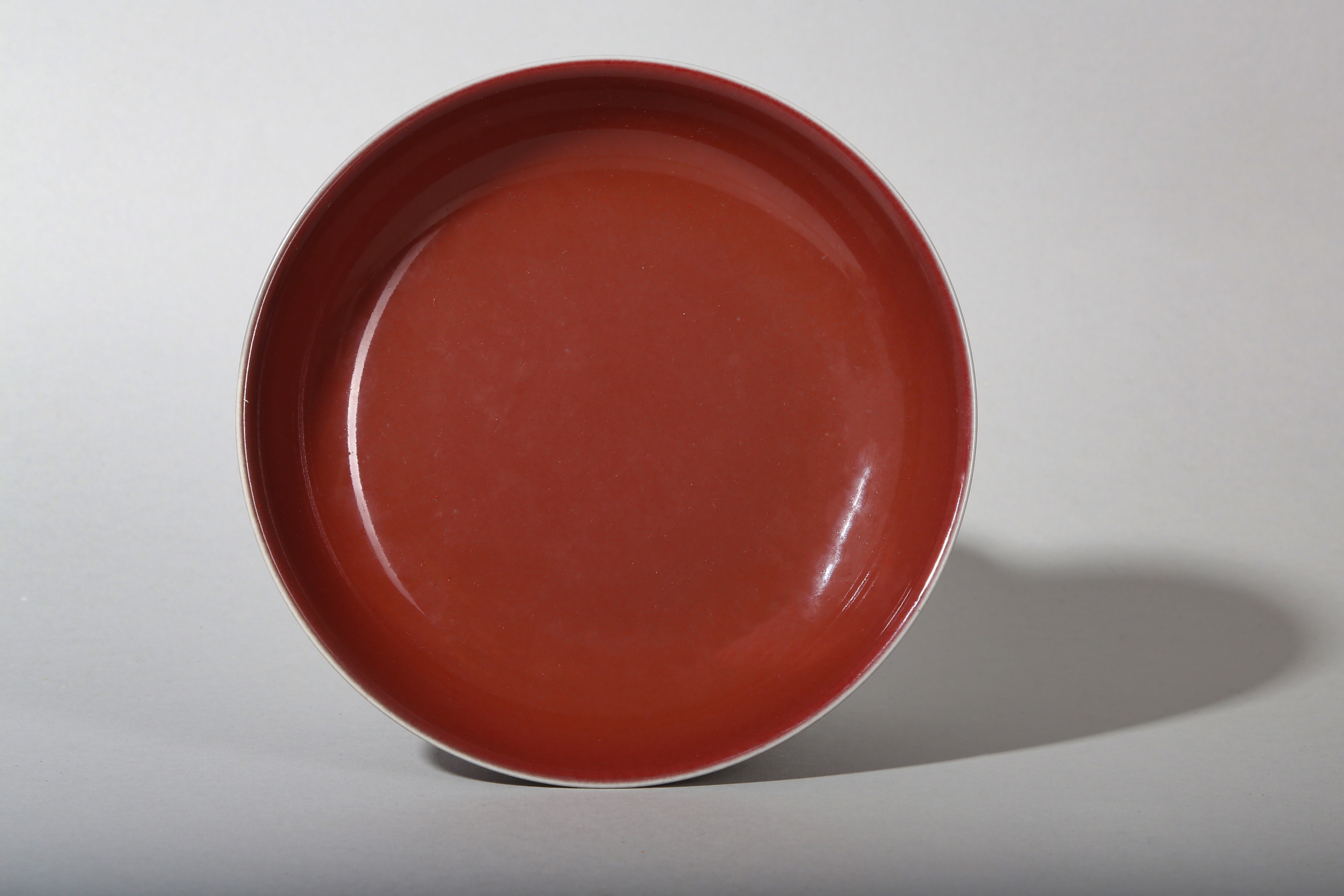 A CHINESE COPPER RED-GLAZED DISH.