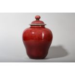 A CHINESE COPPER RED-GLAZED JAR AND COVER.