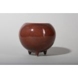 A CHINESE COPPER RED-GLAZED TRIPOD WATER POT.