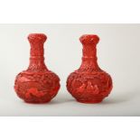 A PAIR OF CHINESE CINNABAR LACQUER 'SCHOLARS' GARLIC MOUTH VASES.
