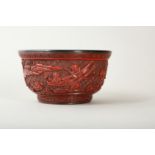 A CHINESE CARVED CINNABAR LACQUER 'BOYS' BOWL.