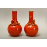 A PAIR OF SALMON RED-GLAZED 'DRAGON' VASES.