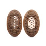 A PAIR OF WOOD CARVED OVAL PANELS.