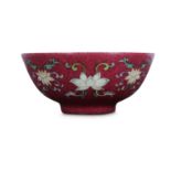 A CHINESE FAMILLE ROSE RUBY-GROUND 'LOTUS' BOWL.