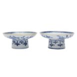 A PAIR OF CHINESE BLUE AND WHITE CUP STANDS.