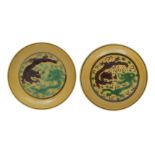 A NEAR PAIR OF CHINESE YELLOW-GROUND GREEN AND AUBERGINE 'DRAGON' DISHES.