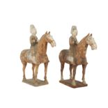 A PAIR OF CHINESE POTTERY HORSERIDERS.