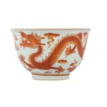 A CHINESE IRON RED 'DRAGON' CUP.