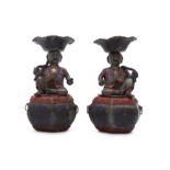 A PAIR OF CHINESE PEWTER 'BOYS' CANDLE HOLDERS.