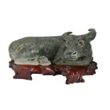 A CHINESE BISCUIT GREEN-GLAZED MODEL OF A BUFFALO.