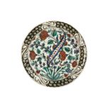 AN IZNIK POTTERY DISH WITH QUATRE FLEURS DECORATION