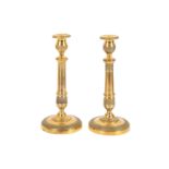 A pair of Empire gilt bronze candlesticks,