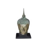 A large late 20th Century carved giltwood Buddha head