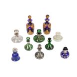 A collection of six early 20th century glass and silvered metal perfume bottles with stoppers